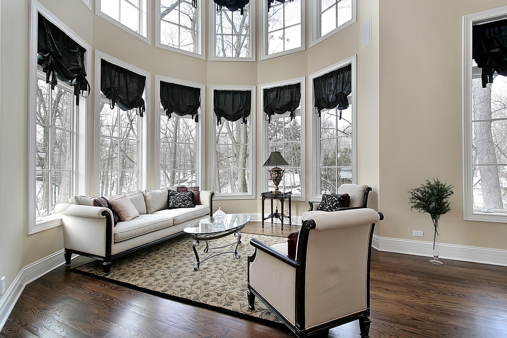 Living room with curved windows, winter outside