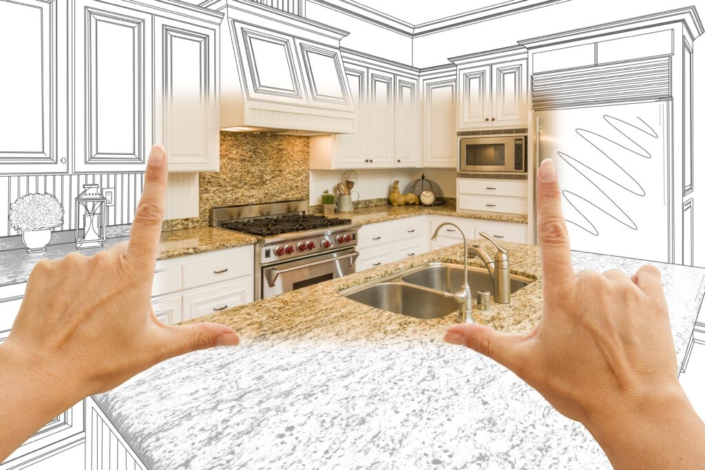 Drawing of kitchen, hands held up to reveal photo of remodeled kitchen