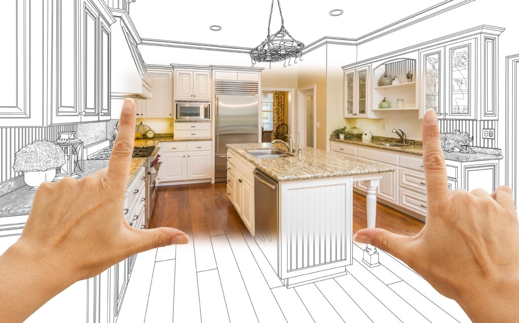 Drawing of kitchen, hands framing photo section, remodeling concept