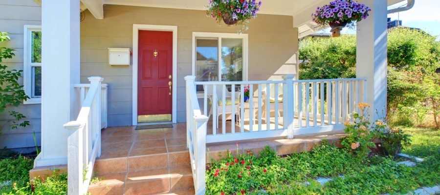 Red front door of home in summer