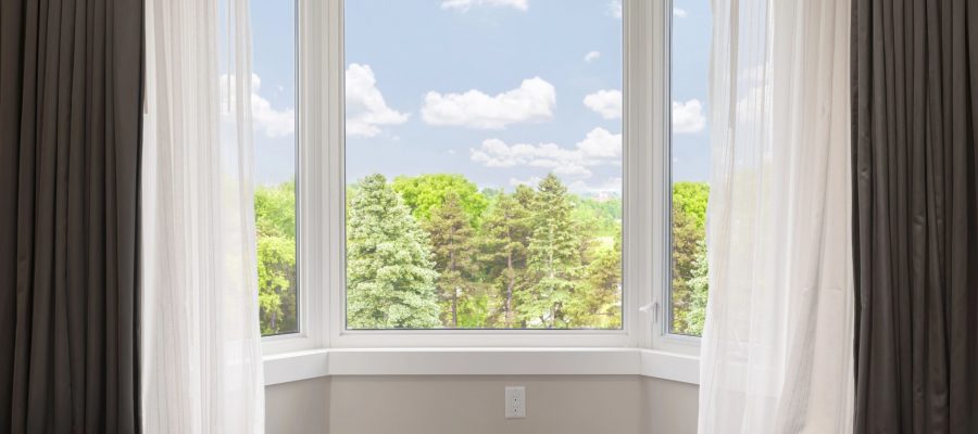 bay window across from bed with view of trees